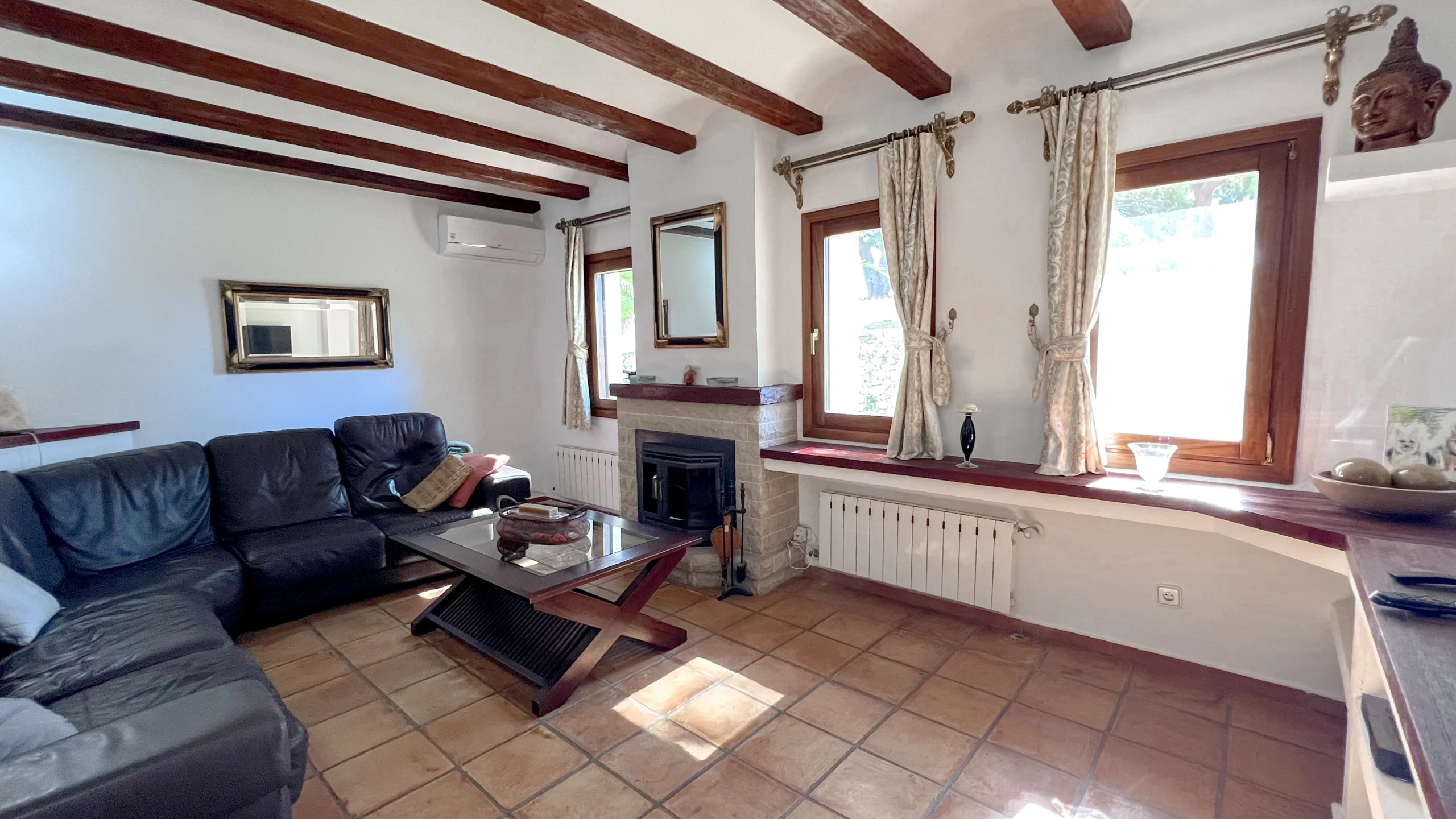 Traditional living space with exposed beams and fireplace in Benissa countryside finca