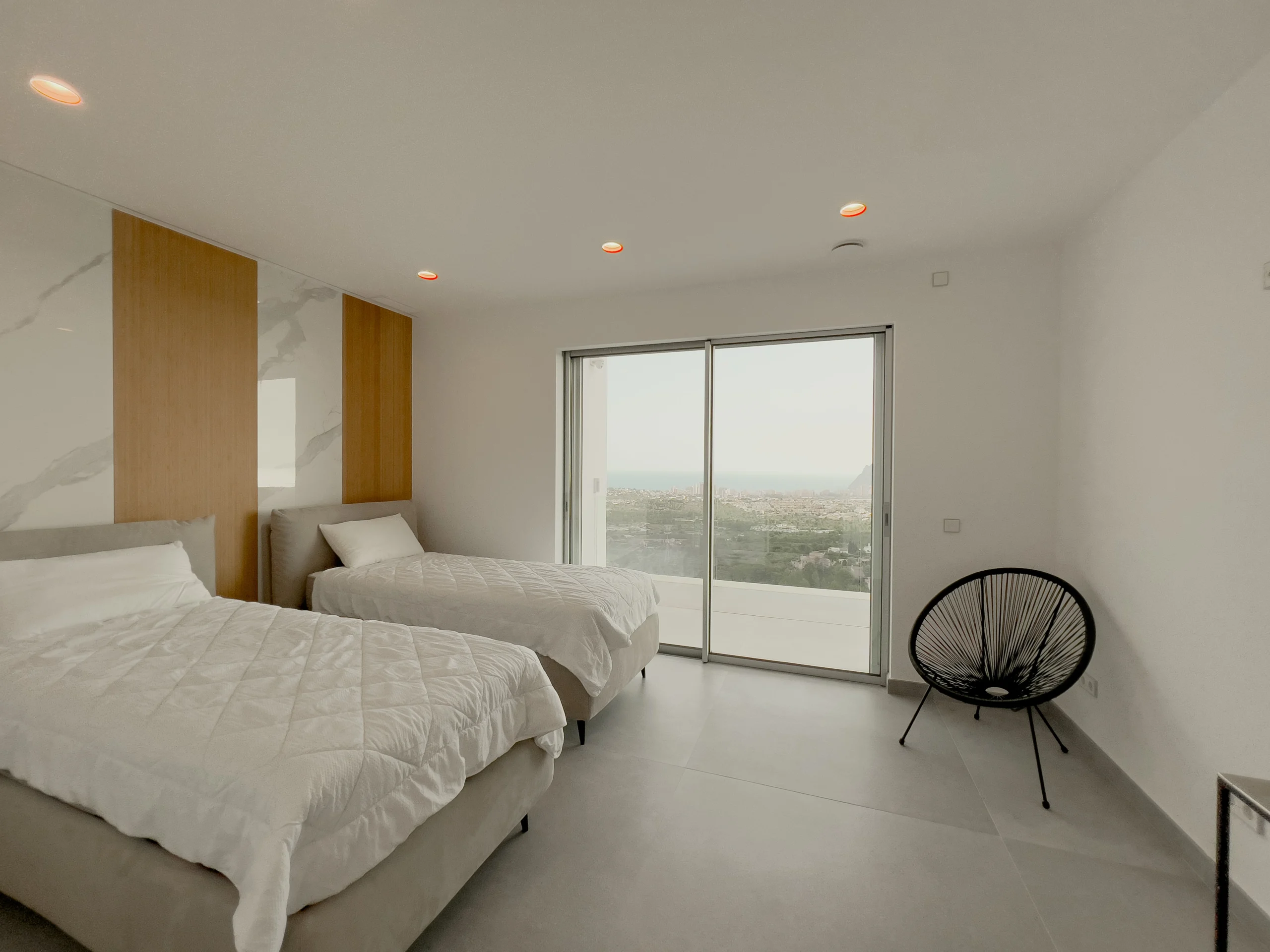 Twin bedroom with sliding terrace doors and open countryside views