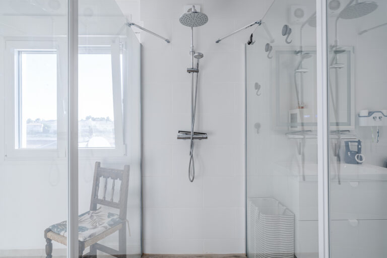 Walk-in rainfall shower with glass doors in a modern sea-view villa in Calpe