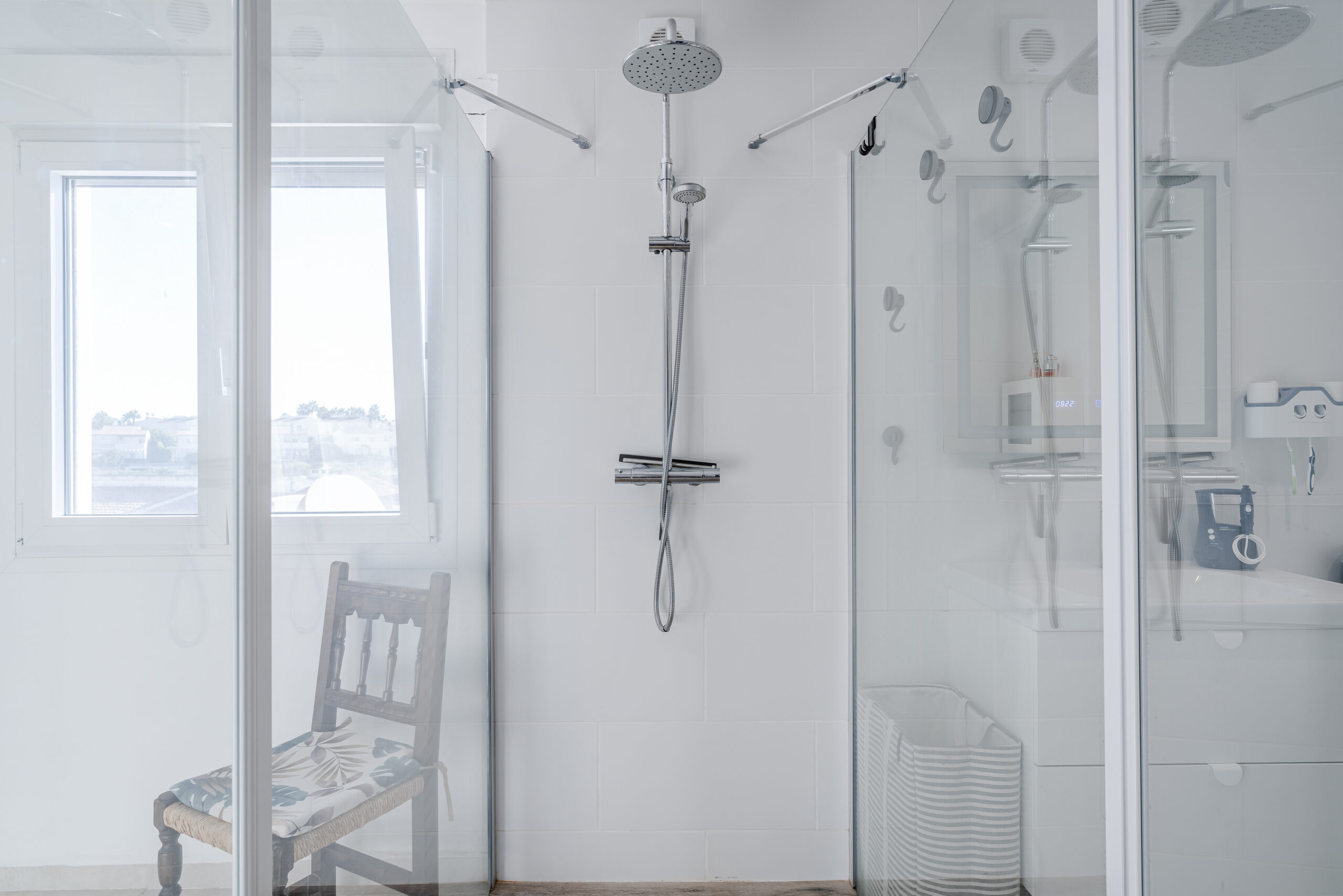 Walk-in rainfall shower with glass doors in a modern sea-view villa in Calpe