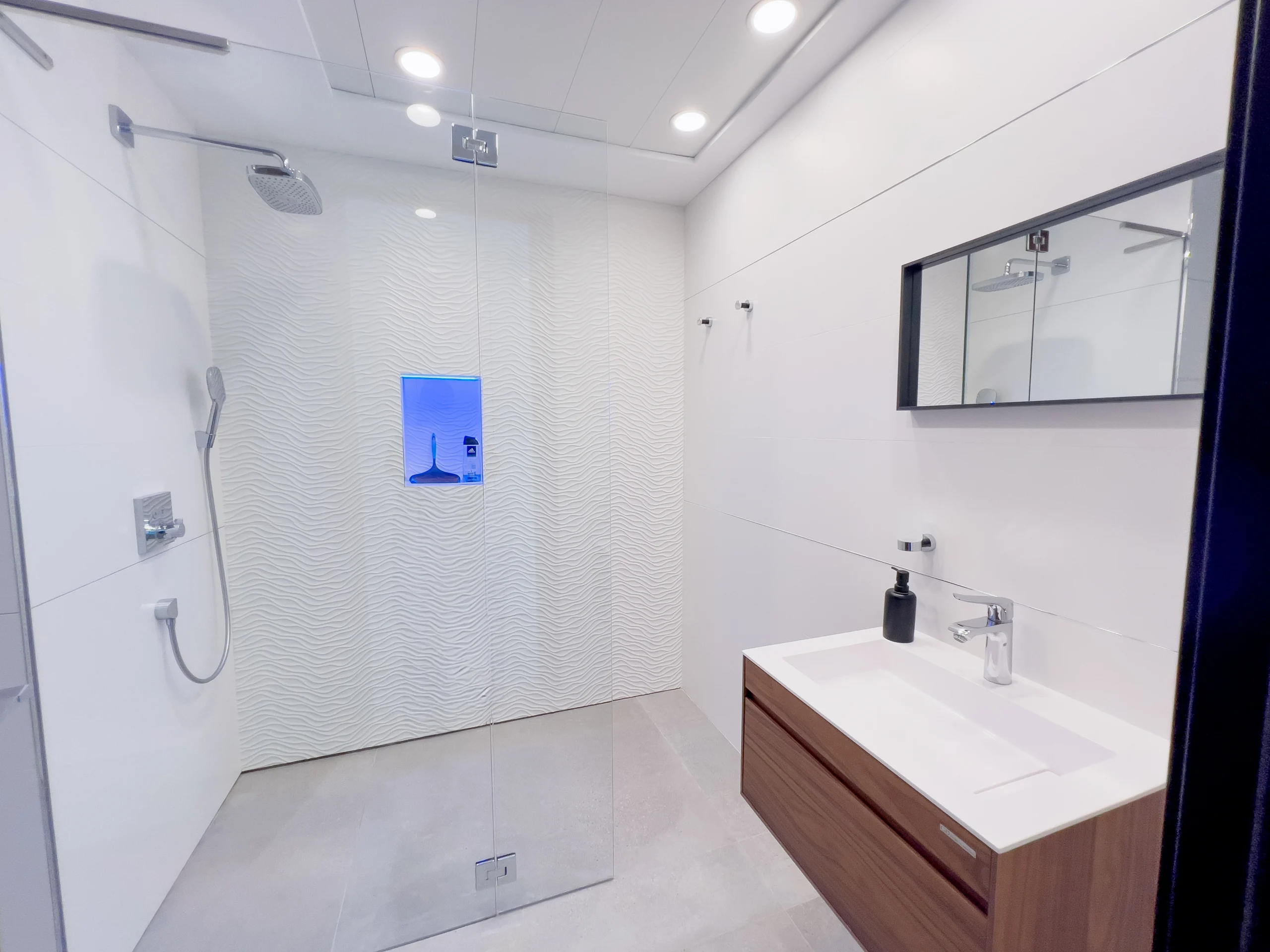 White minimalist bathroom with walk-in rain shower and floating vanity