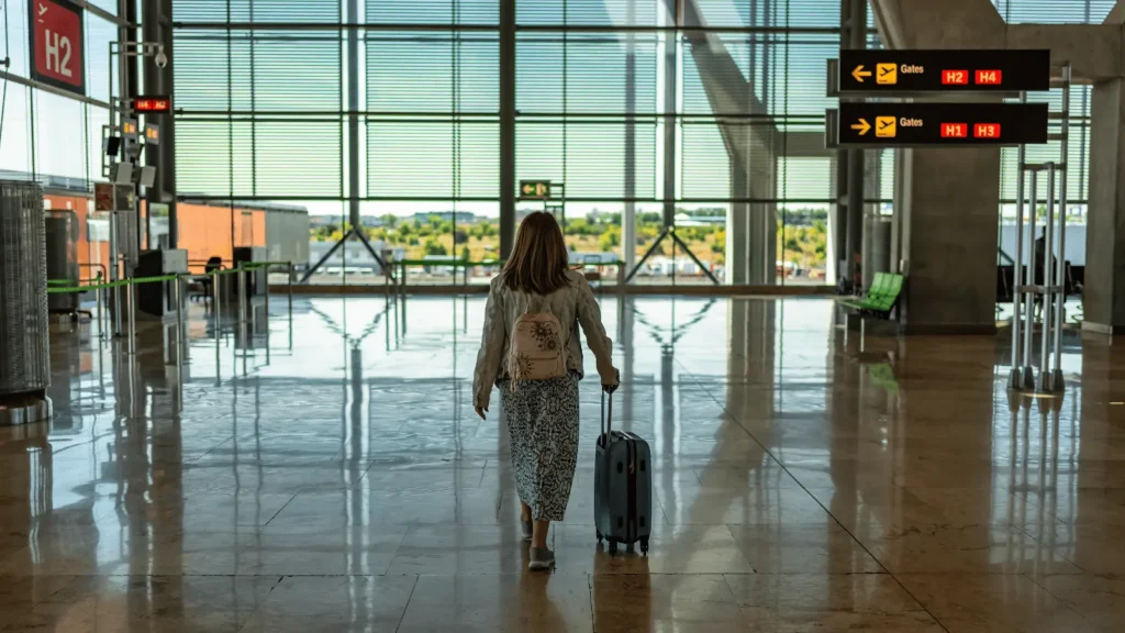 Traveller walking through Alicante Airport terminal before heading to Calpe