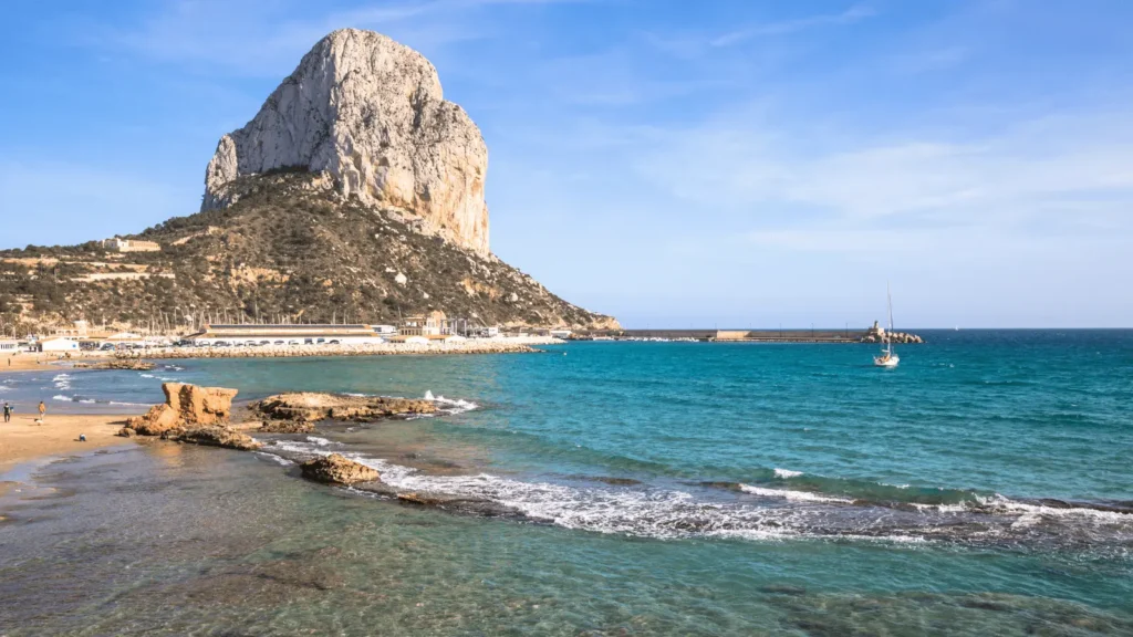 Peñón de Ifach overlooking Calpe beach and turquoise Mediterranean Sea on the Costa Blanca