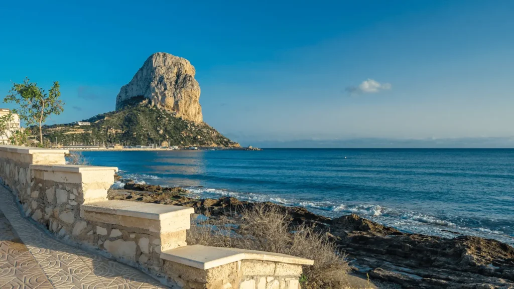 Peñón de Ifach and Calpe coastline under clear blue skies on the Costa Blanca, Spain