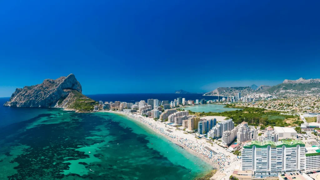 Aerial view of Calpe coastline with Peñón de Ifach, showing beachfront apartments and the Costa Blanca landscape