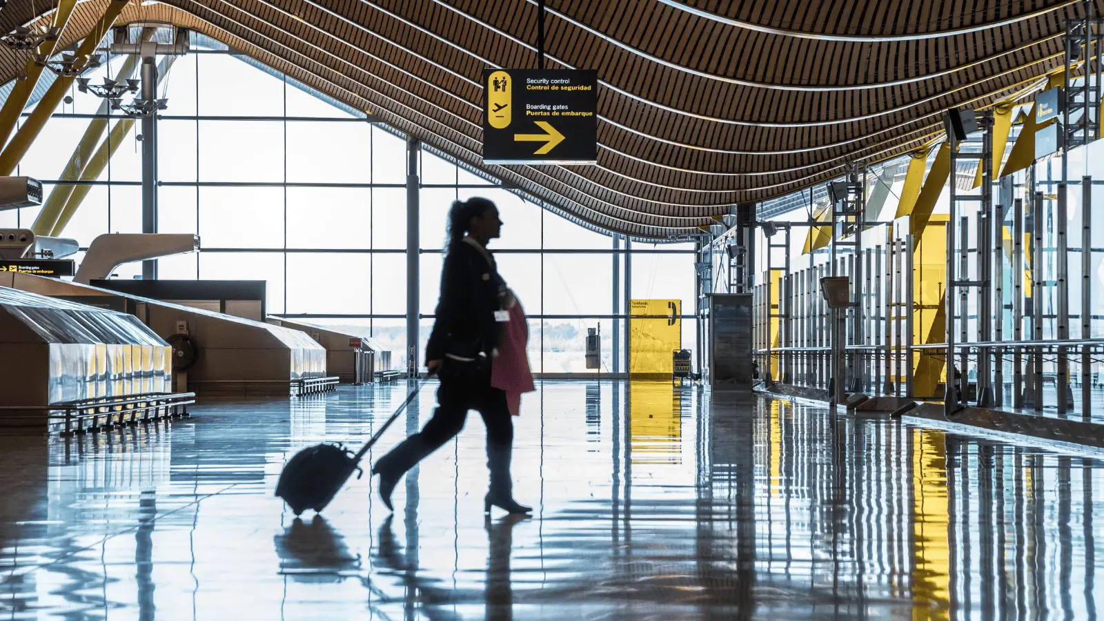Passenger walking through Alicante Airport terminal before travelling to Calpe