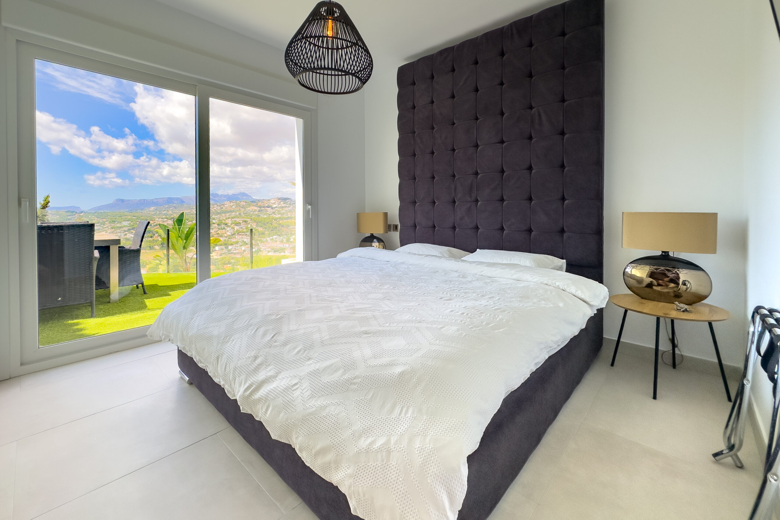 Bedroom with large windows and open views in a Moraira villa