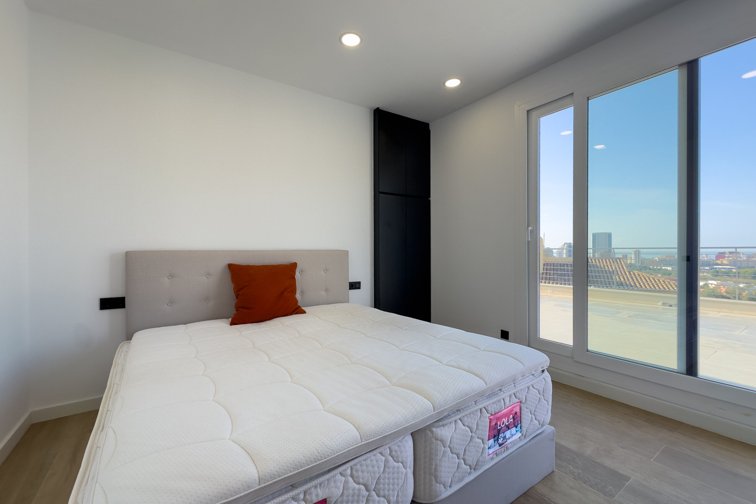 Bedroom with sliding doors and natural light in a modern villa in Casanova, Calpe
