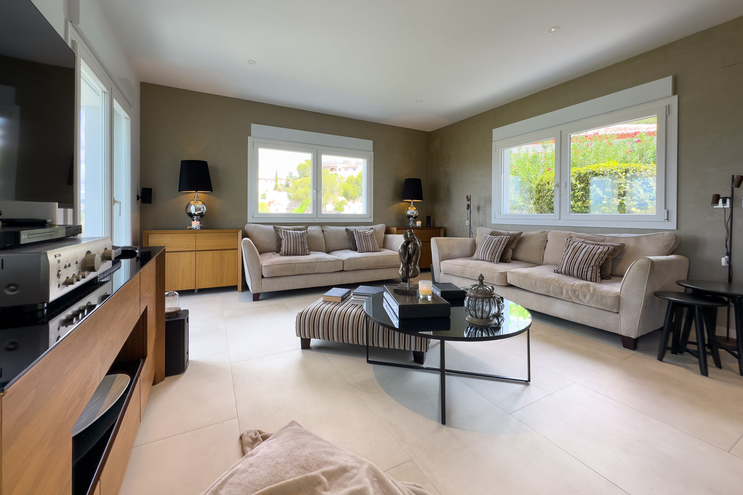 Bright living room with seating and windows in a Moraira sea view villa