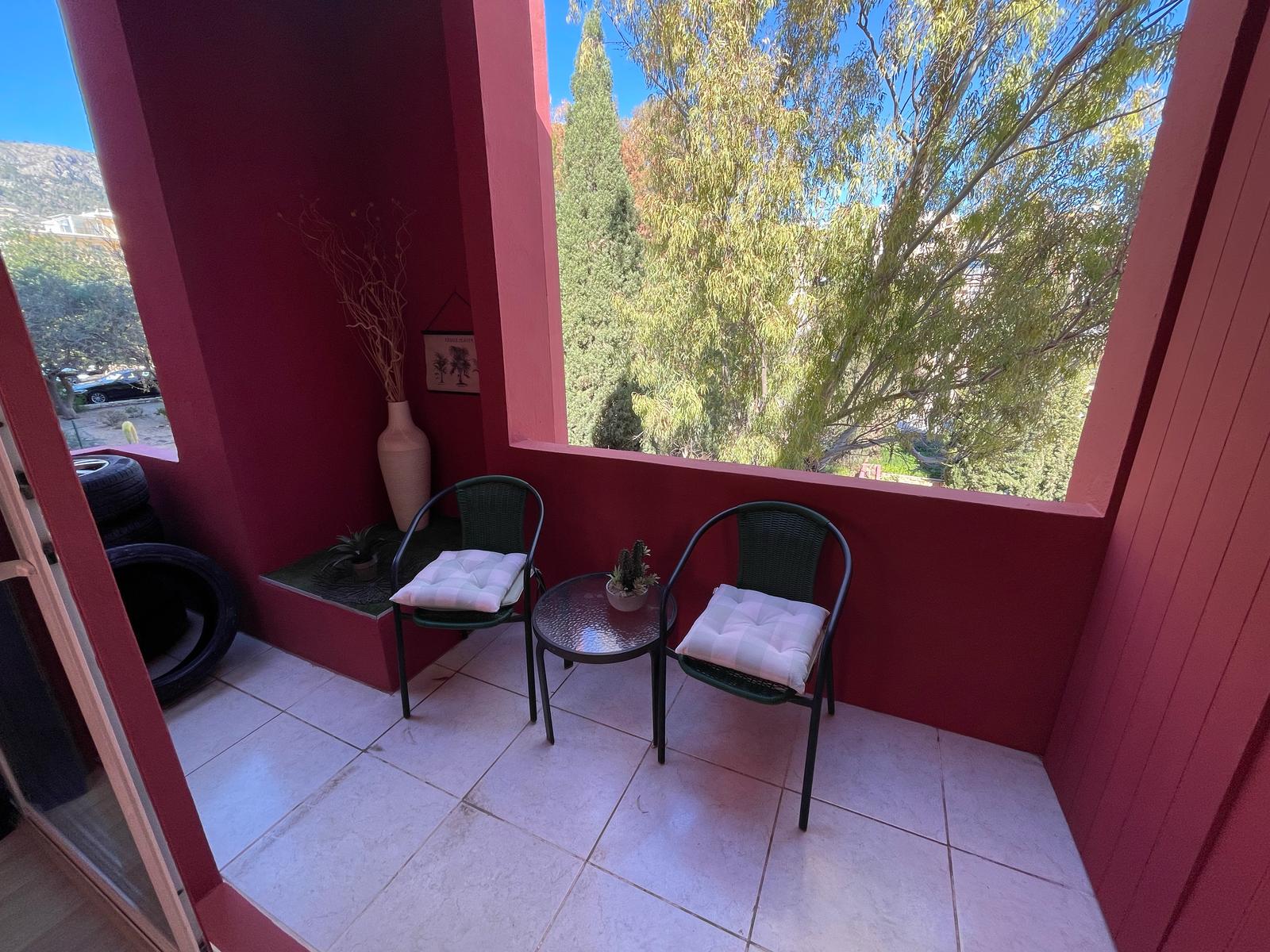 Covered terrace with seating at a La Muralla Roja apartment in Calpe