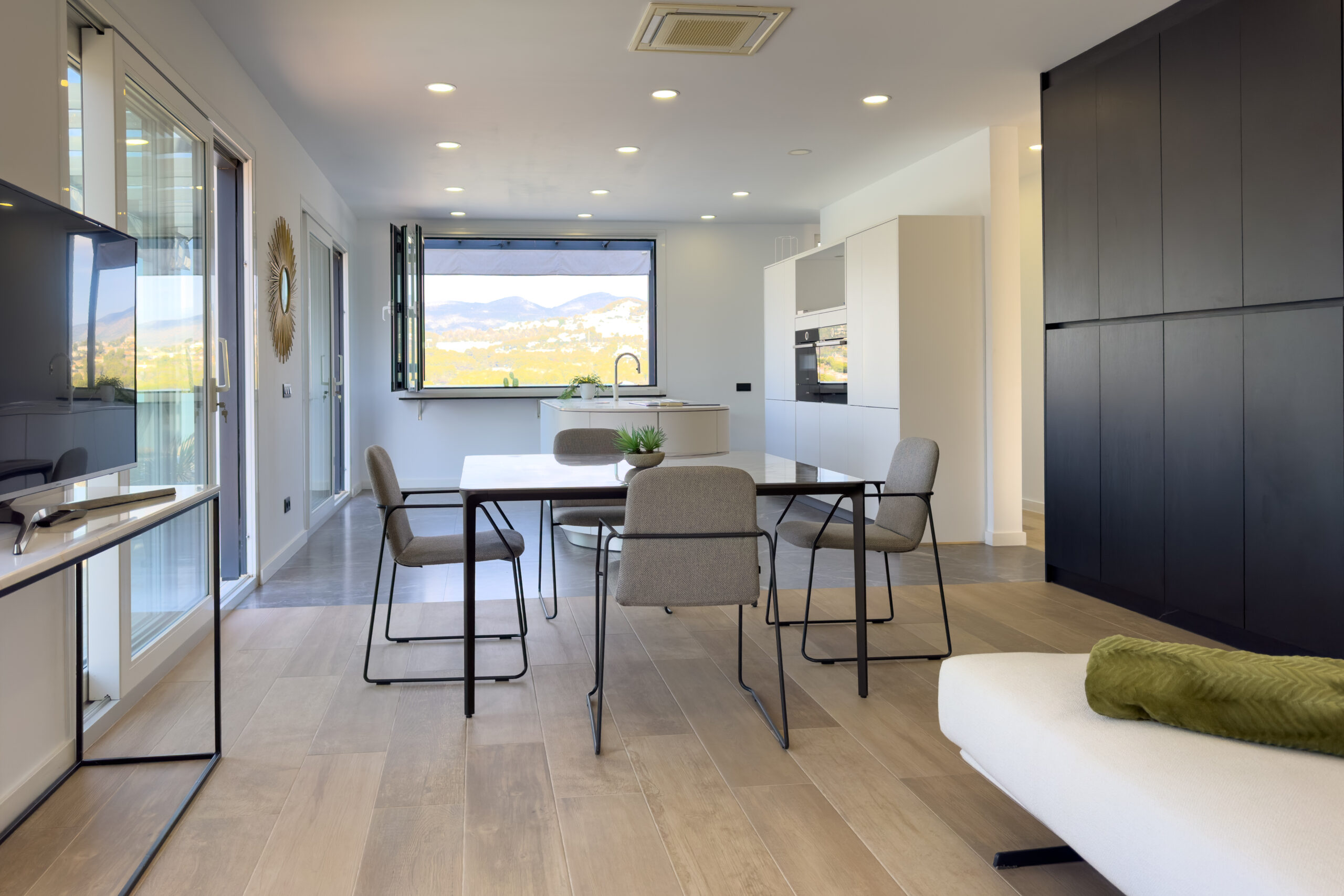 Dining and lounge area with wide windows in a modern villa in Calpe