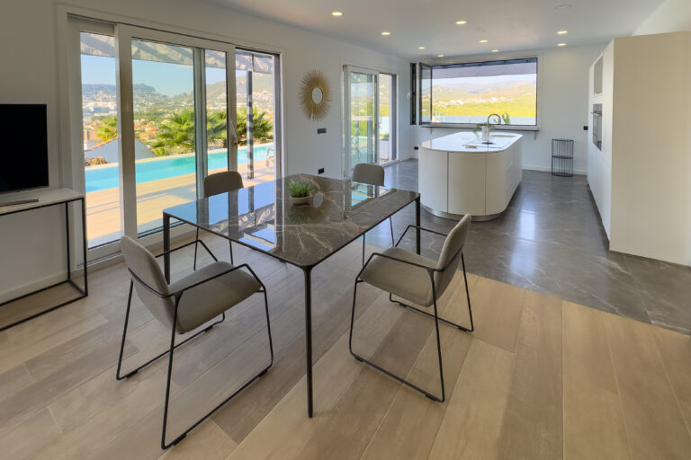 Dining area with large windows and open views in a modern villa in Calpe