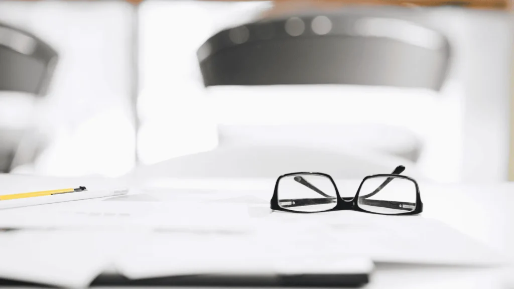 Property sale paperwork on a desk in Spain, illustrating the documents needed to sell a property and avoid delays.