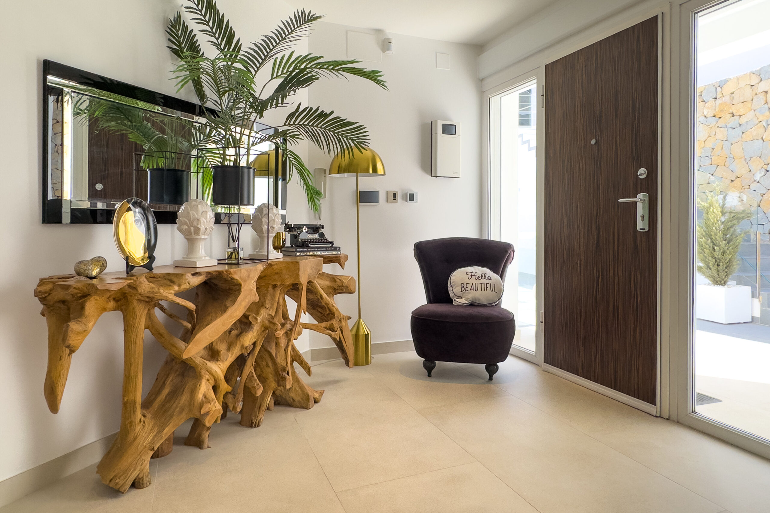 Entrance hall with console table and decor inside a villa in Moraira