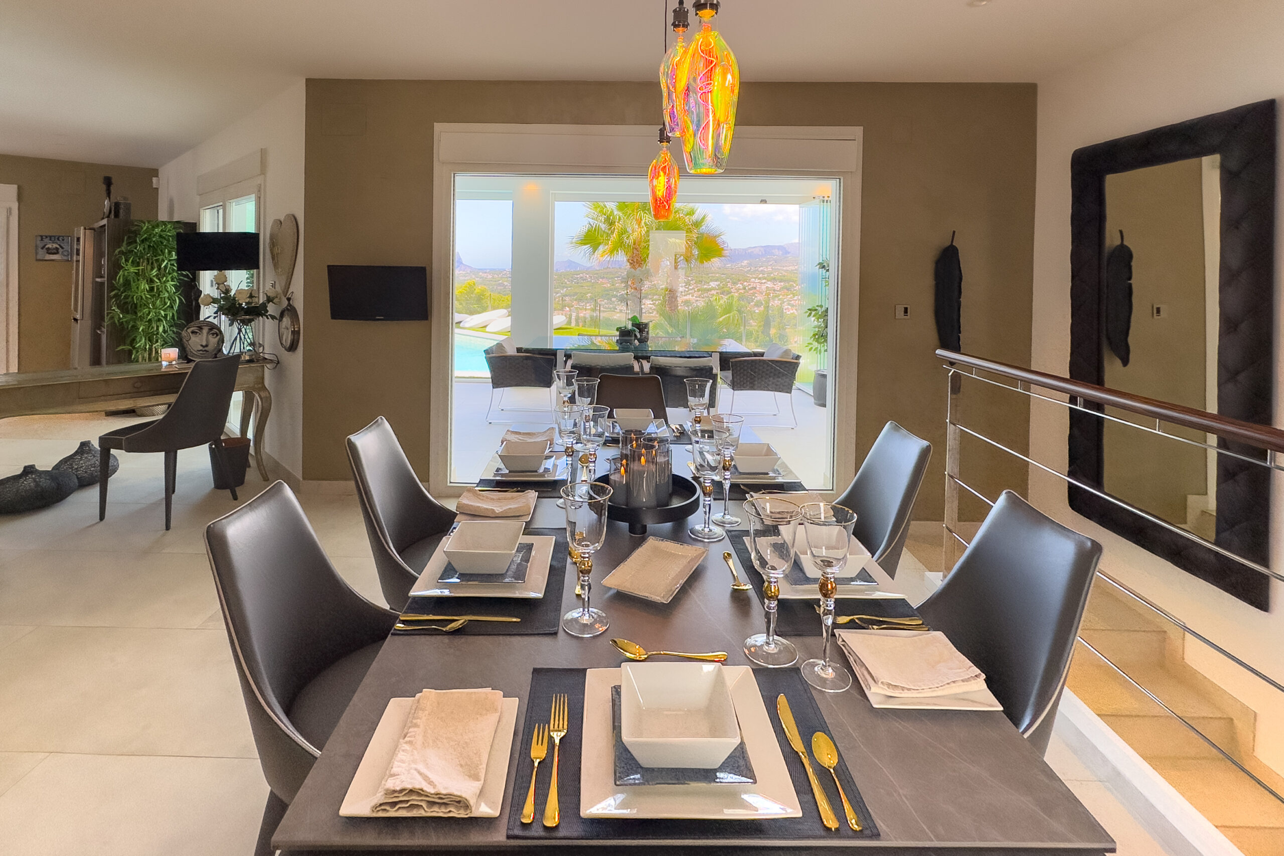 Long dining table in open plan living space in Moraira villa