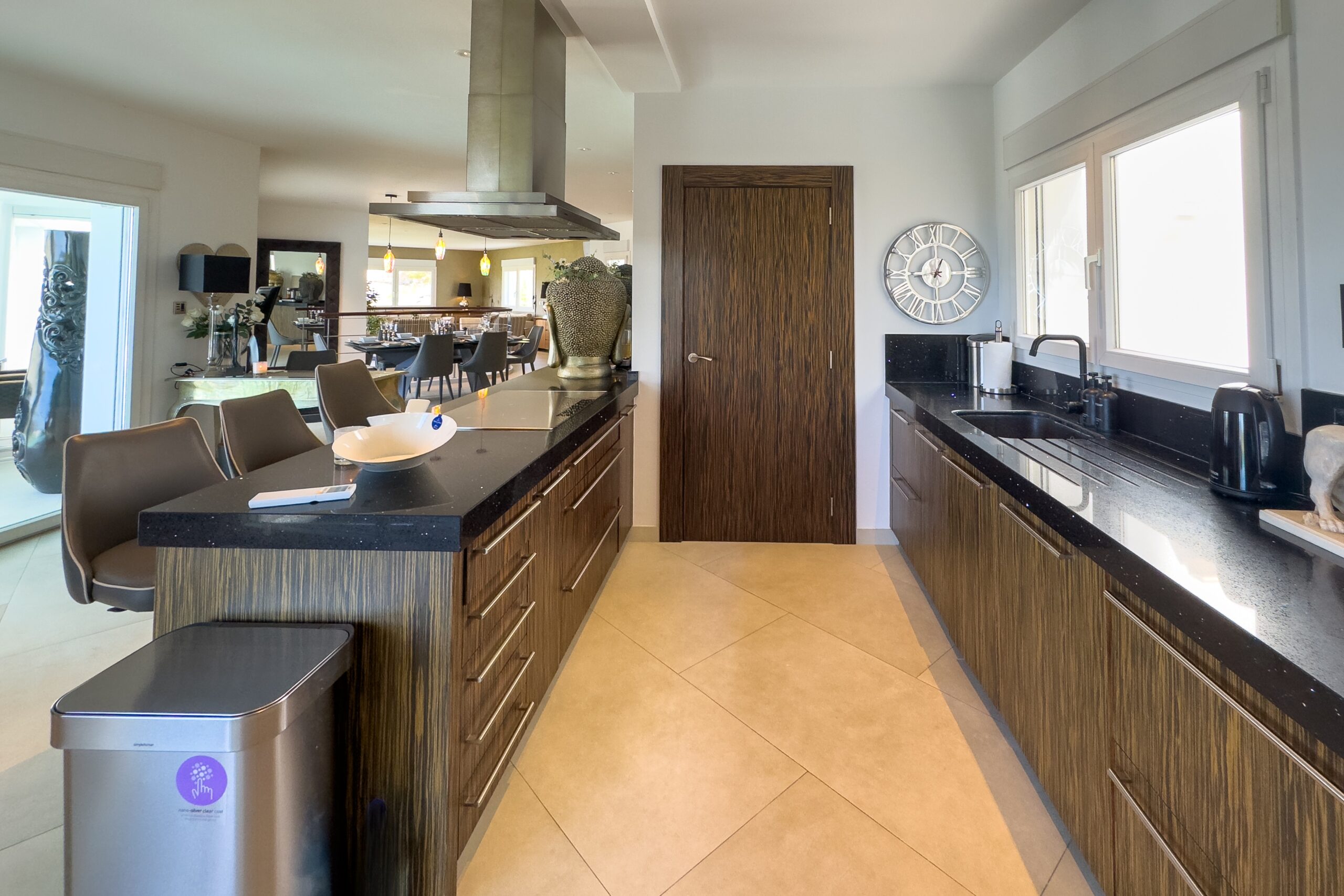 Long kitchen worktop with island and natural light in Moraira villa