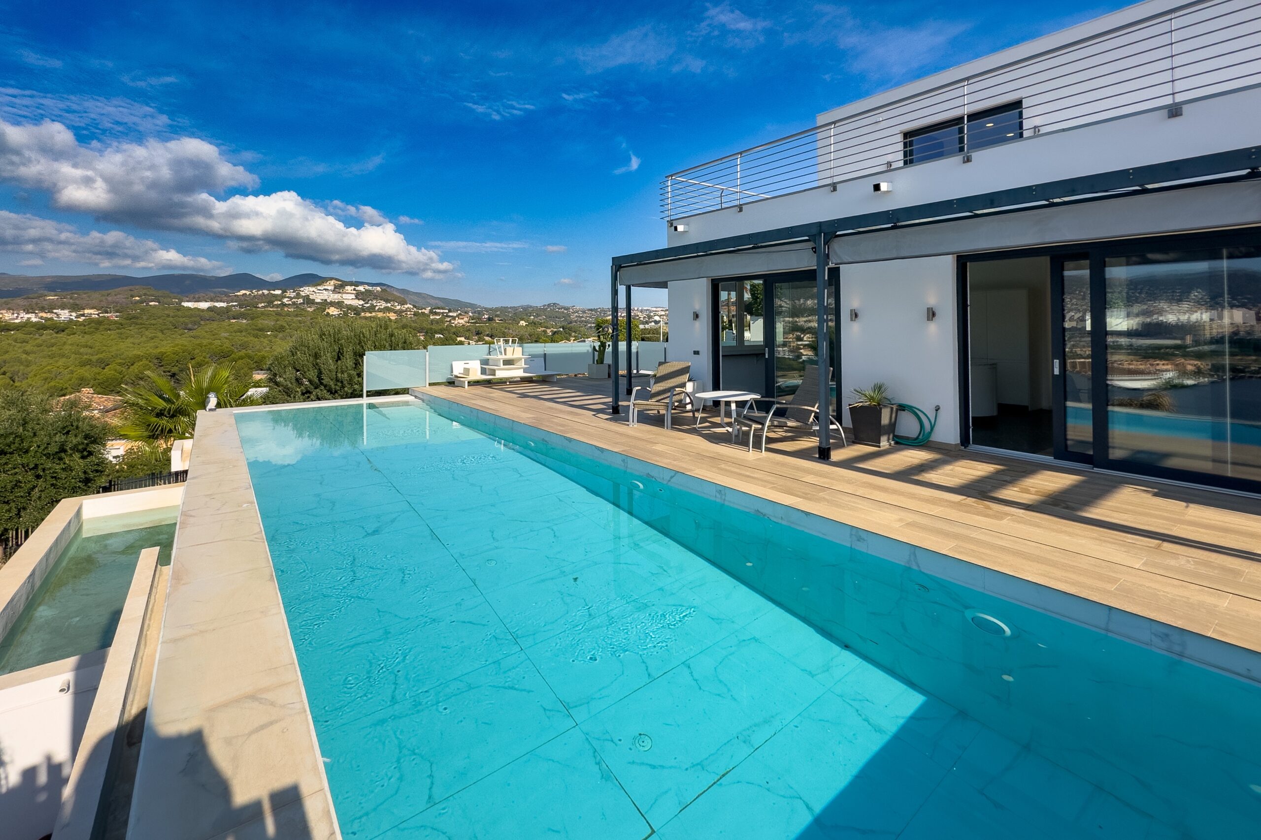 Long pool with open sea and mountain views at a modern Calpe villa