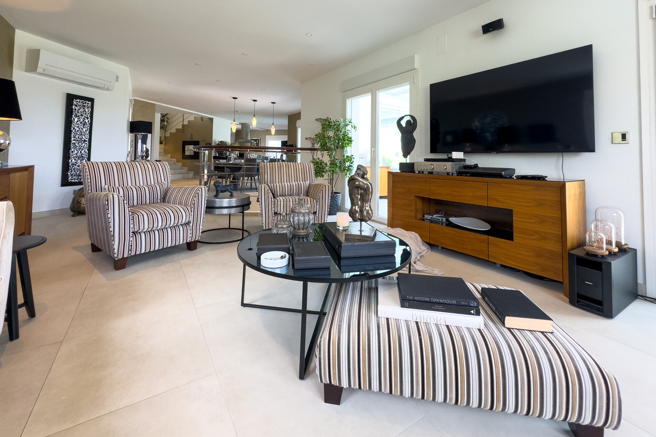 Lounge area with TV and seating in an open plan villa interior in Moraira