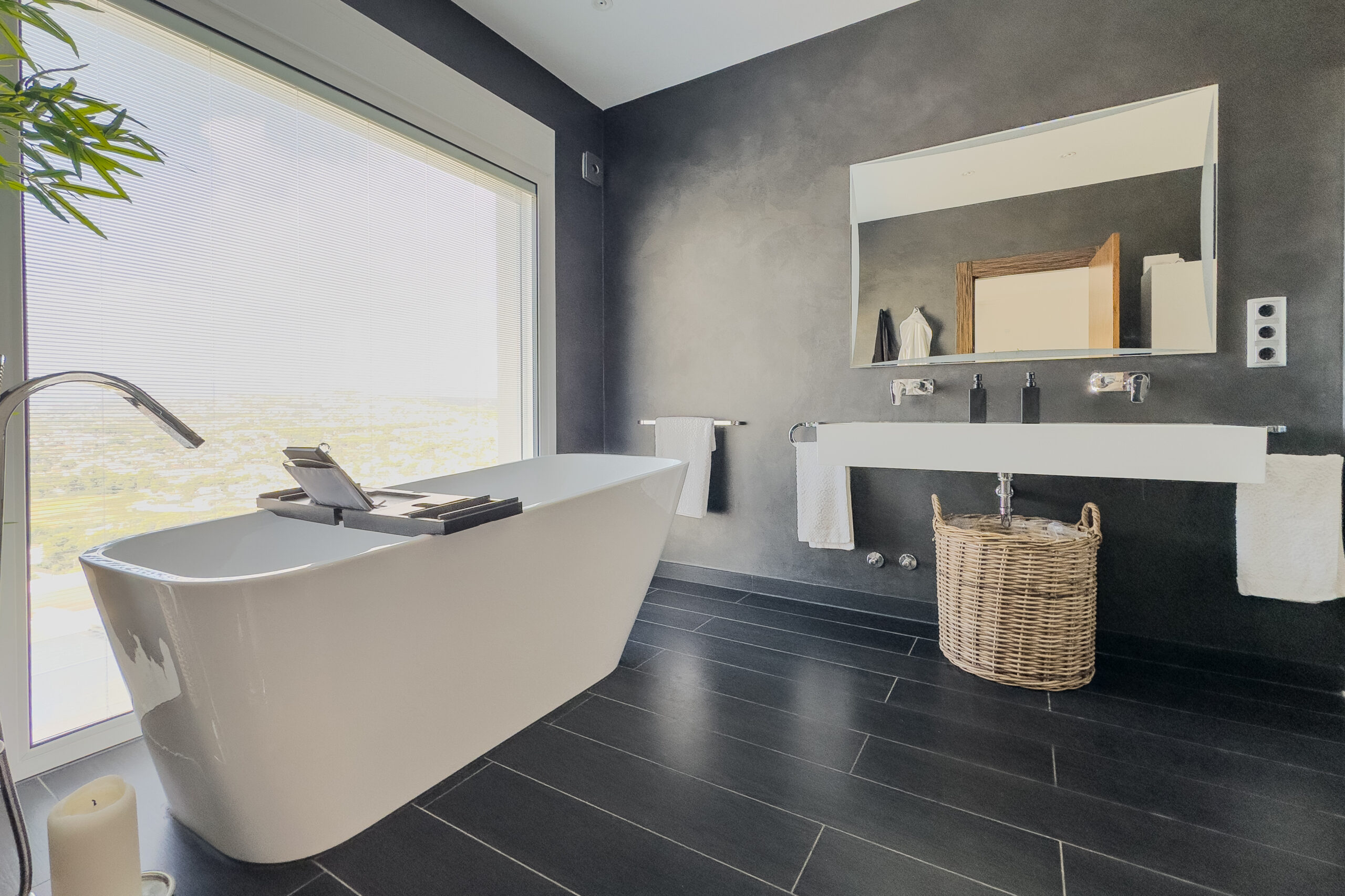 Modern bathroom with freestanding bath and large window in Moraira villa