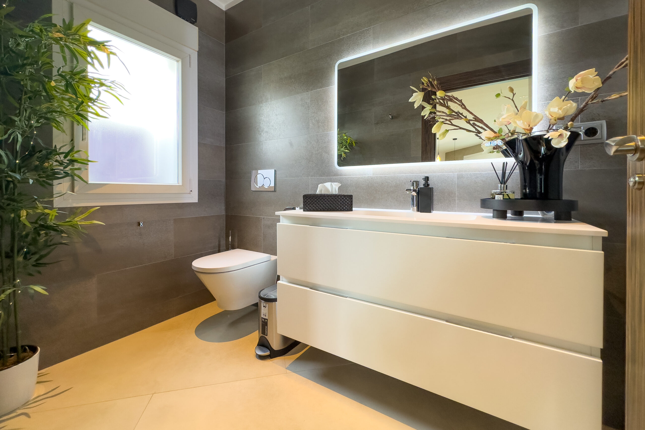Modern bathroom with vanity unit, mirror and window in Moraira villa