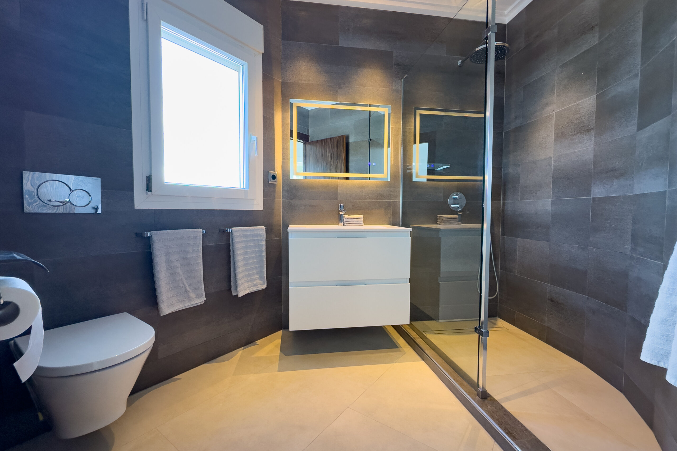 Modern ensuite bathroom with walk-in shower in a villa in Moraira