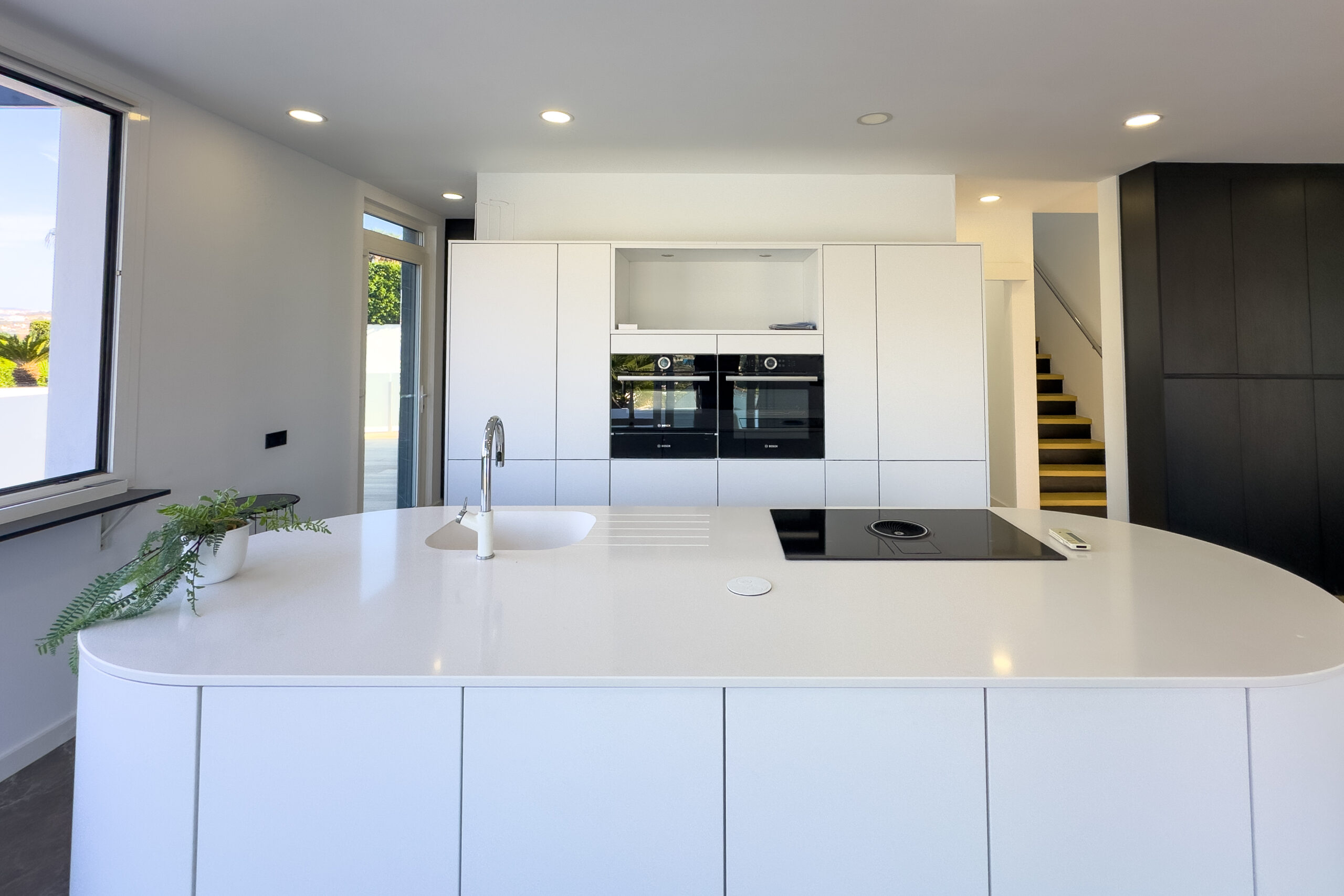 Modern kitchen island with white units in a Calpe villa interior