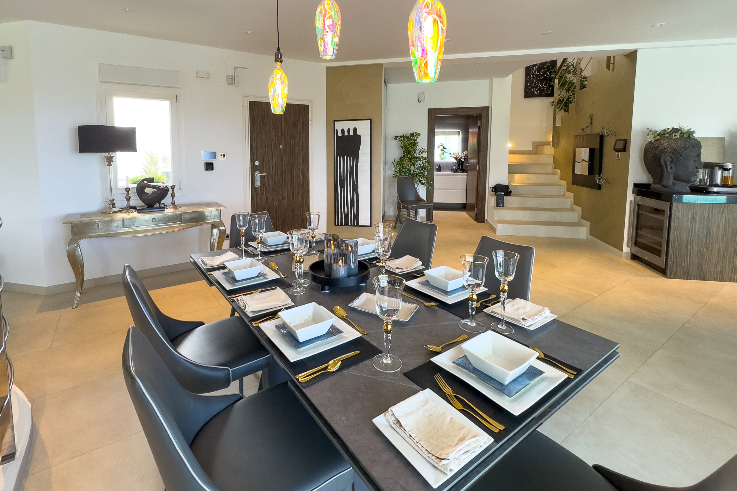 Open plan dining area set for guests inside a Moraira villa