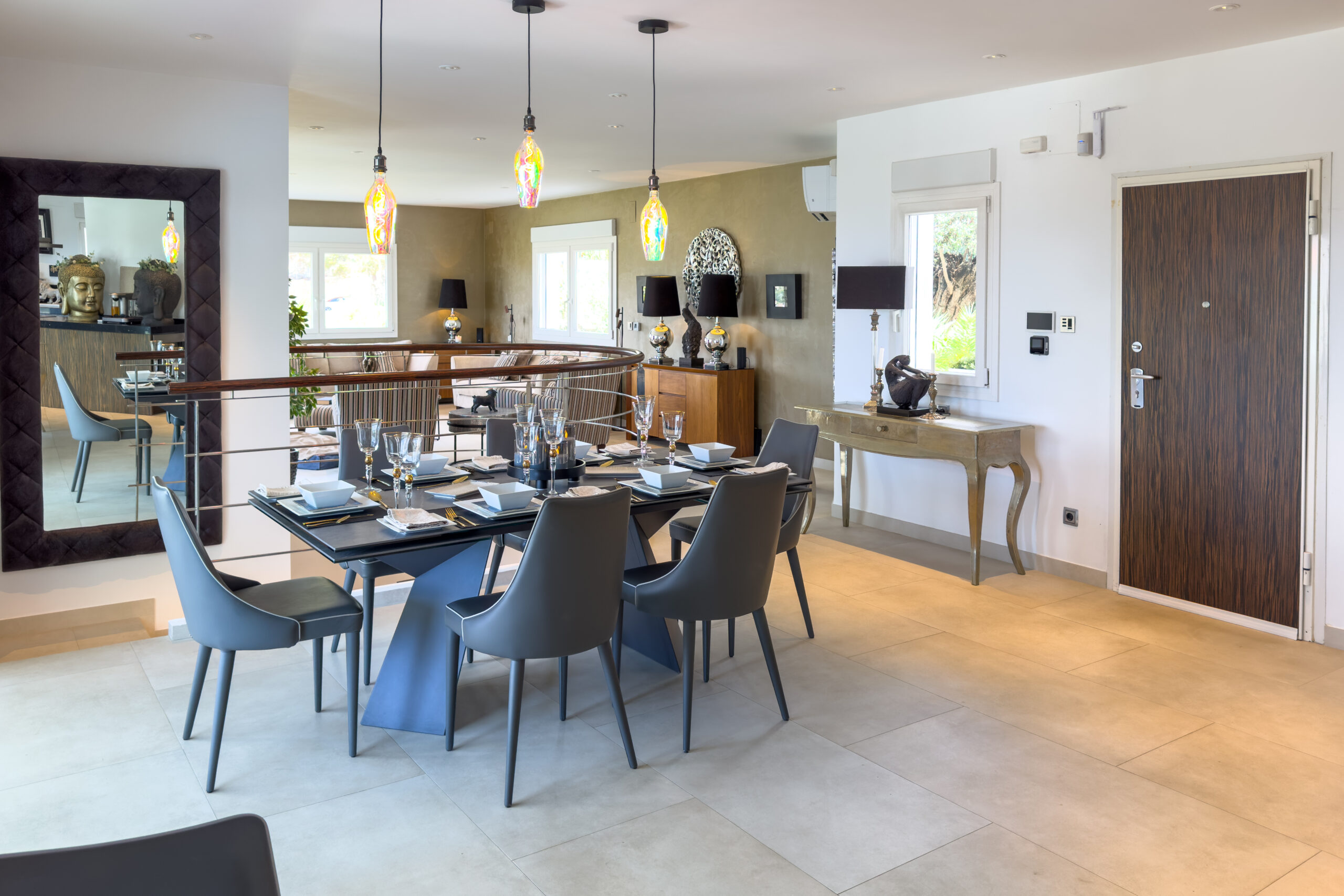 Open plan dining area with table and pendant lights in a Moraira villa