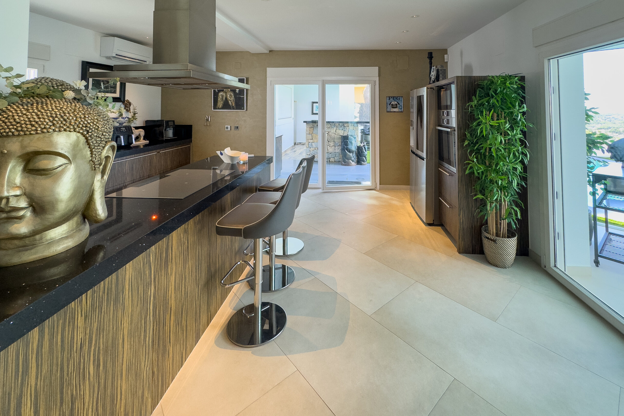 Open plan kitchen with island and terrace doors in Moraira villa