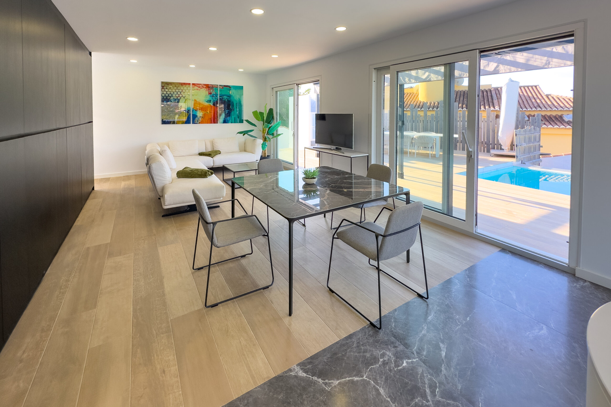 Open plan living and dining area with sliding doors to the pool in a Calpe villa