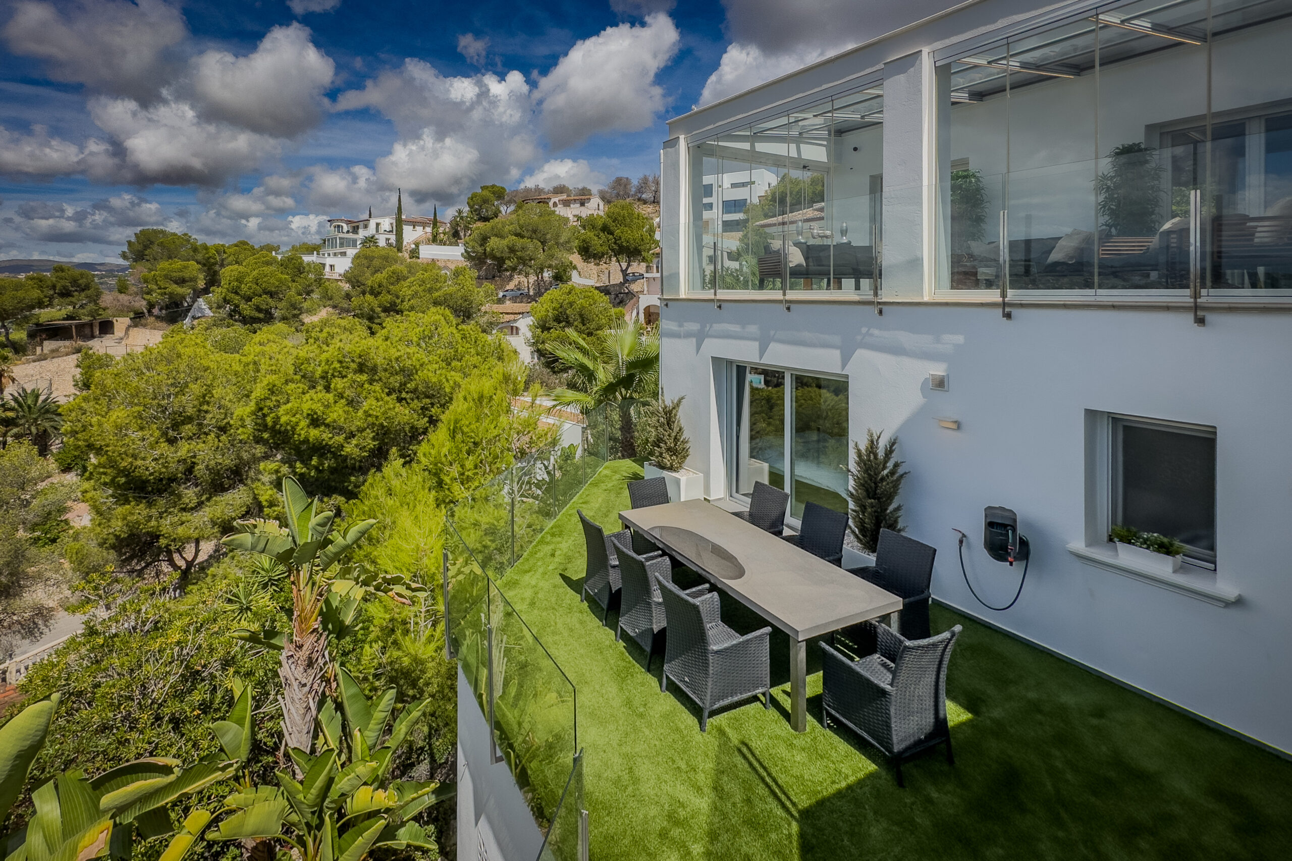 Outdoor dining terrace and garden area at a villa in Moraira