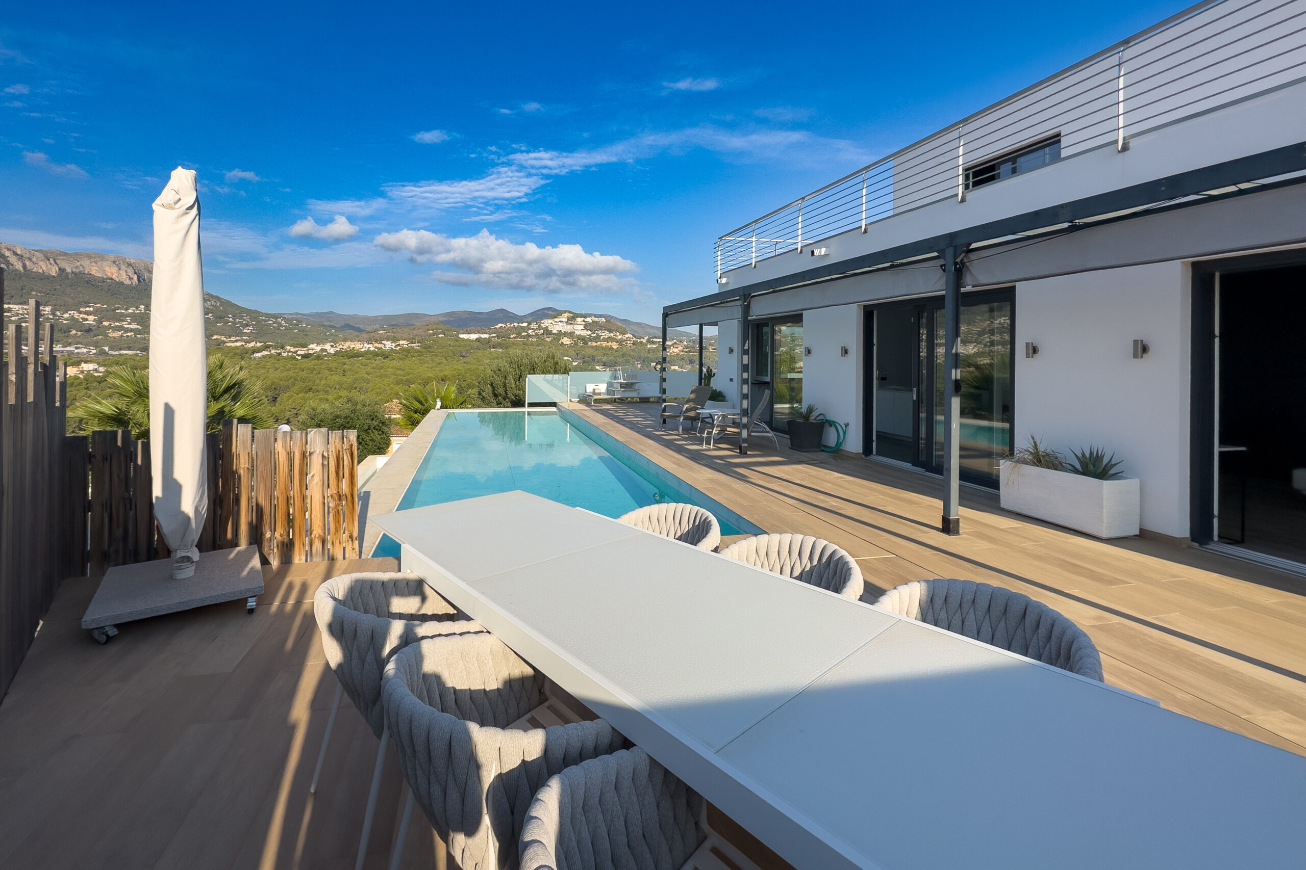 Outdoor dining terrace beside the pool at a villa in Casanova, Calpe