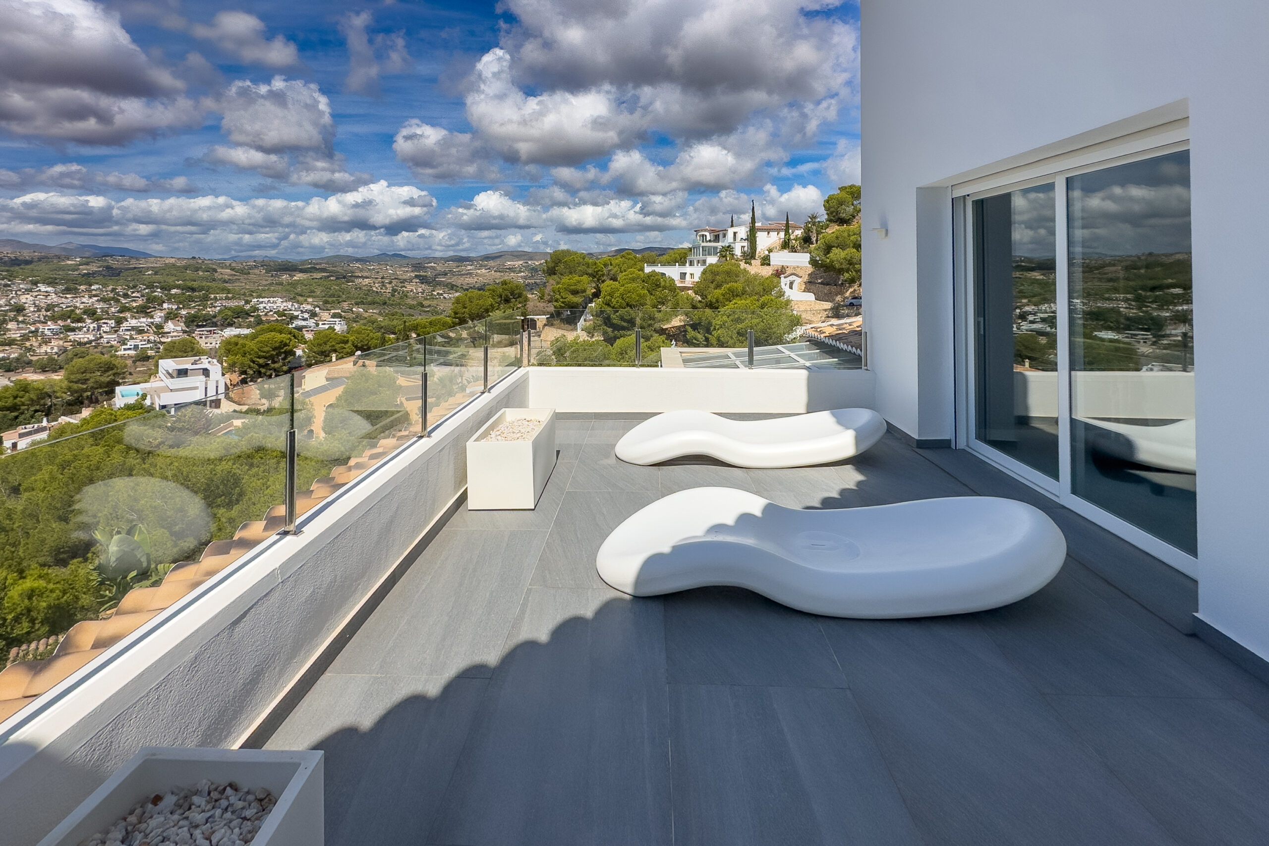 Terrace with sun loungers and open views from a Moraira villa
