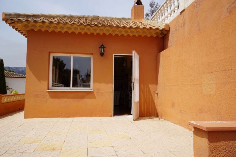 Outdoor BBQ area with tiled terrace at a Mediterranean villa near La Calalga Beach in Calpe.