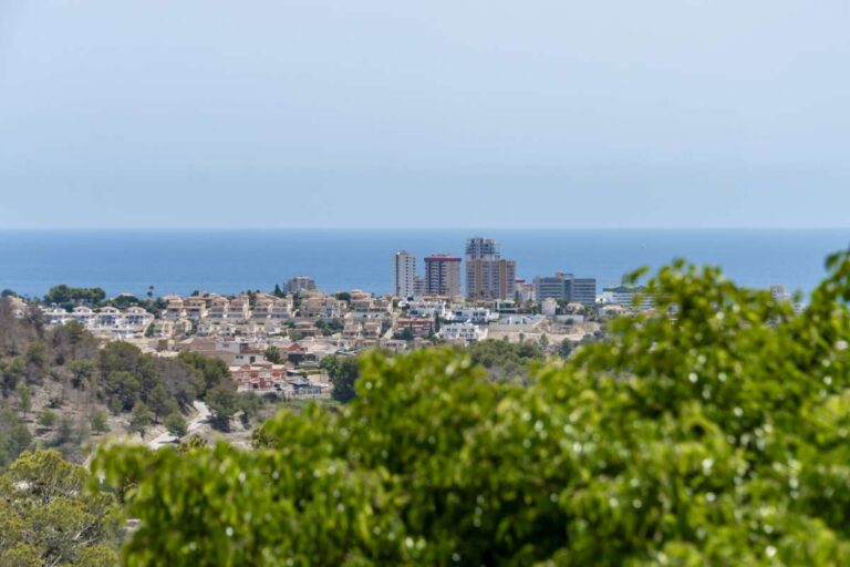 Open sea views from a semi-detached house in Calpe with greenery and the coastline in the distance