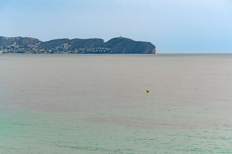 Sea views from a beachfront apartment by La Fossa Beach in Calpe looking across the bay towards the surrounding coastline