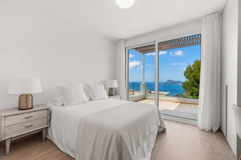 Bedroom inside a modern villa in Altea Hills with terrace access, Mediterranean Sea views, mountain views and bright neutral interior