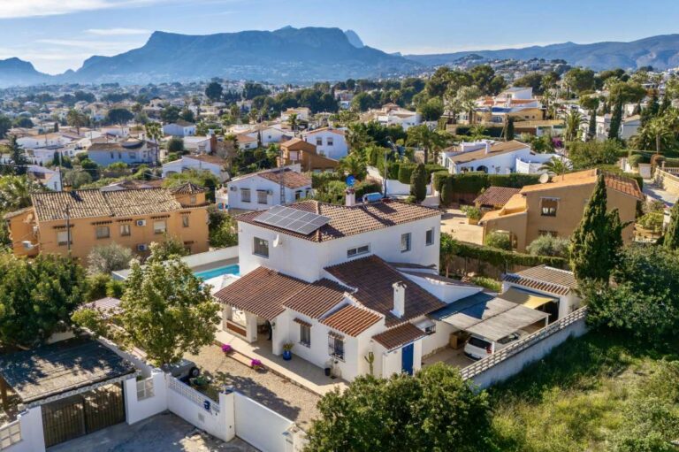 Aerial view of a contemporary villa in a peaceful residential area of Calpe with mountain and neighbourhood views.