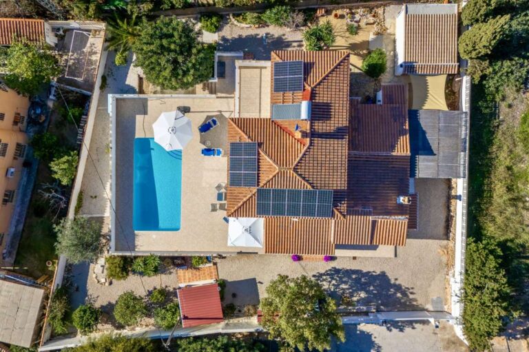 Aerial view of a contemporary villa in Calpe with private swimming pool, terrace, garden and solar panels.