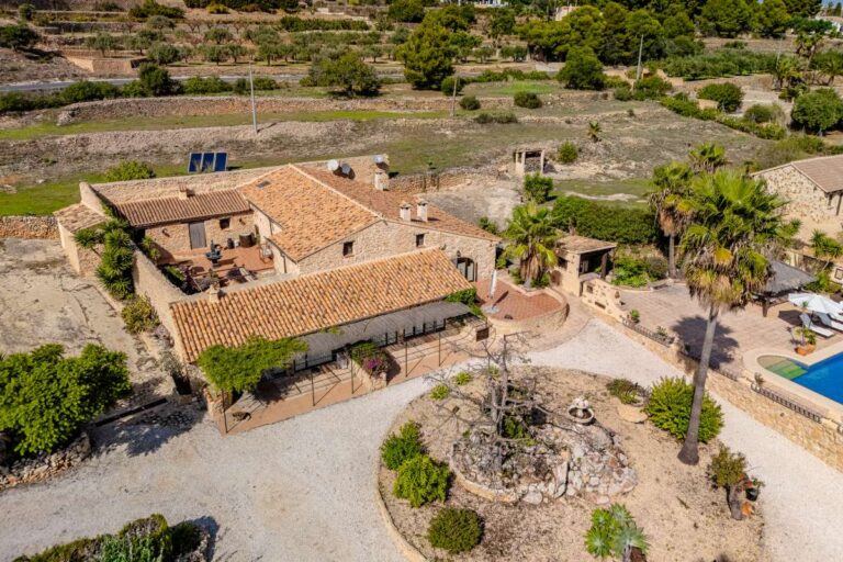 Aerial view of a historic finca in Benissa with large private grounds, stone buildings, pool area and countryside surroundings