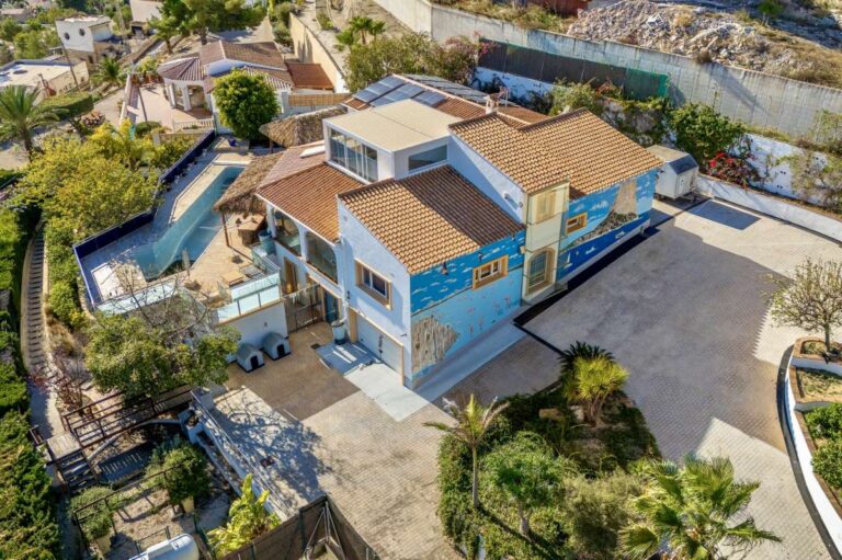 Aerial view of a large private villa in Calpe with pool area, driveway, garden space and Mediterranean surroundings