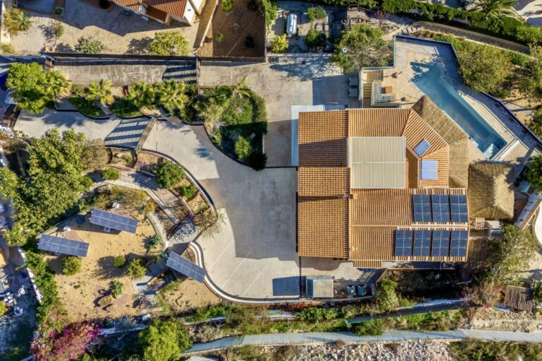 Aerial view of a large private villa in Calpe with swimming pool, spacious plot, driveway and outdoor areas