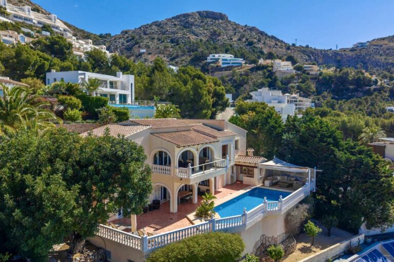 Aerial view of a Mediterranean villa in Altea Hills with private swimming pool, large terrace, mountain views and surrounding villas