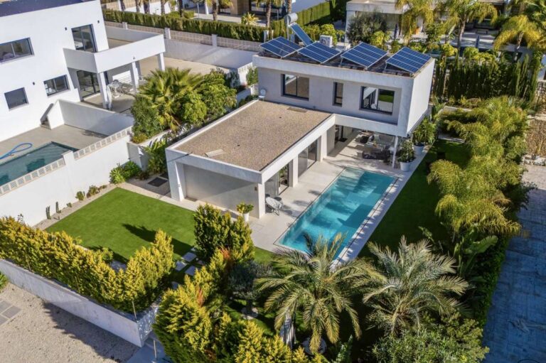 Aerial view of a modern oasis villa in Calpe with private swimming pool, tropical garden and terrace areas.