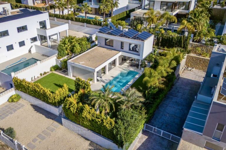 Aerial view of a modern oasis villa near Arenal-Bol Beach in Calpe with private pool, garden and surrounding residential area.