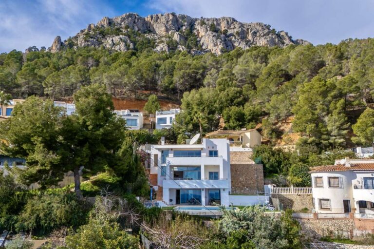 Aerial view of a modern spacious villa in Calpe with private pool, garden area and mountain surroundings.