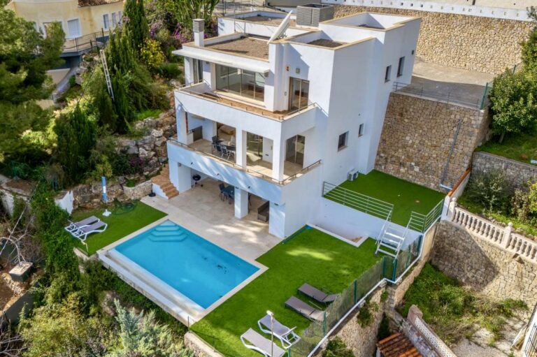 Aerial view of a modern spacious villa in Calpe with private swimming pool, terrace and landscaped garden.