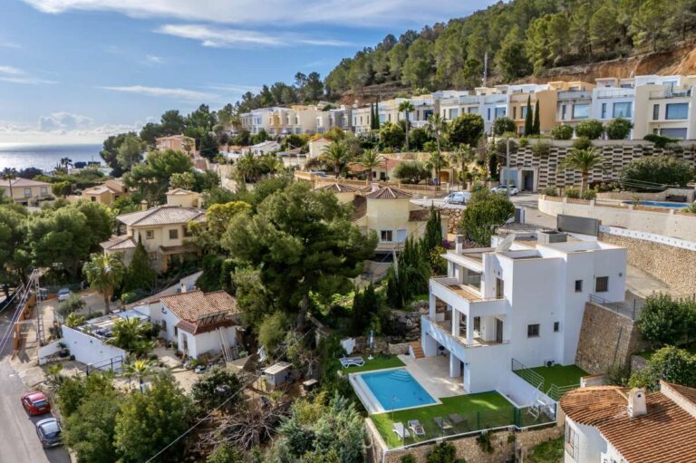 Aerial view of a modern spacious villa in Calpe with surrounding residential area and mountain views.