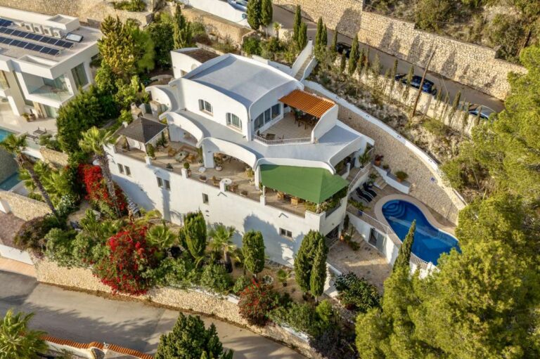 Aerial view of a panoramic sea view villa in Benissa with private pool, terraces, Mediterranean gardens and hillside surroundings