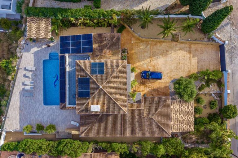 Aerial view of a premium coastal villa on the Benissa Costa with private pool, solar panels, terraces and surrounding garden areas